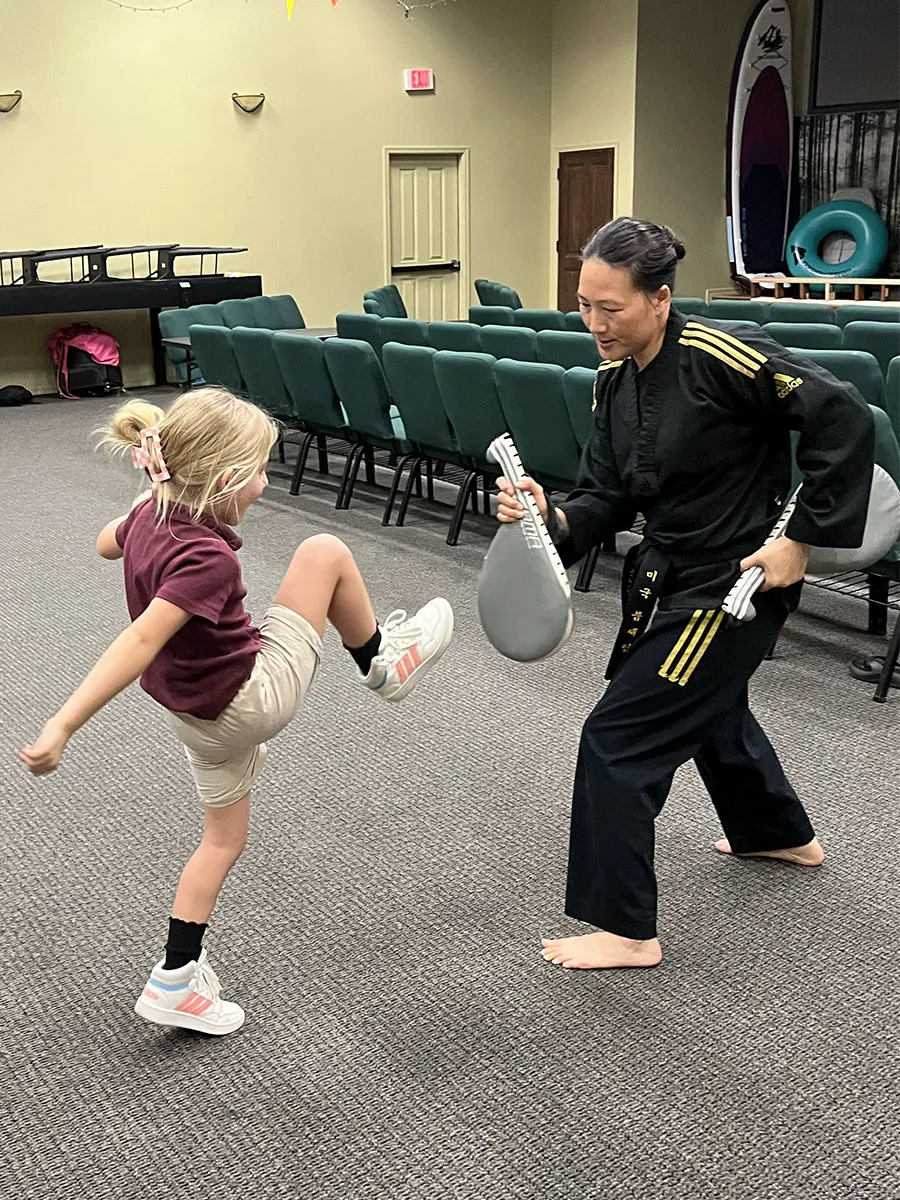 kids-martial-arts-karate-class Children in martial arts karate class wearing white gi uniforms
