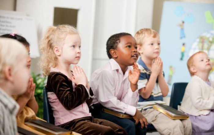 Pre-school children learning to pray
